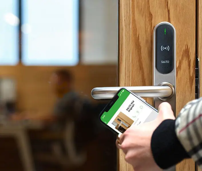 SALTO XS4 smart door lock being opened with the SALTO mobile app on a phone