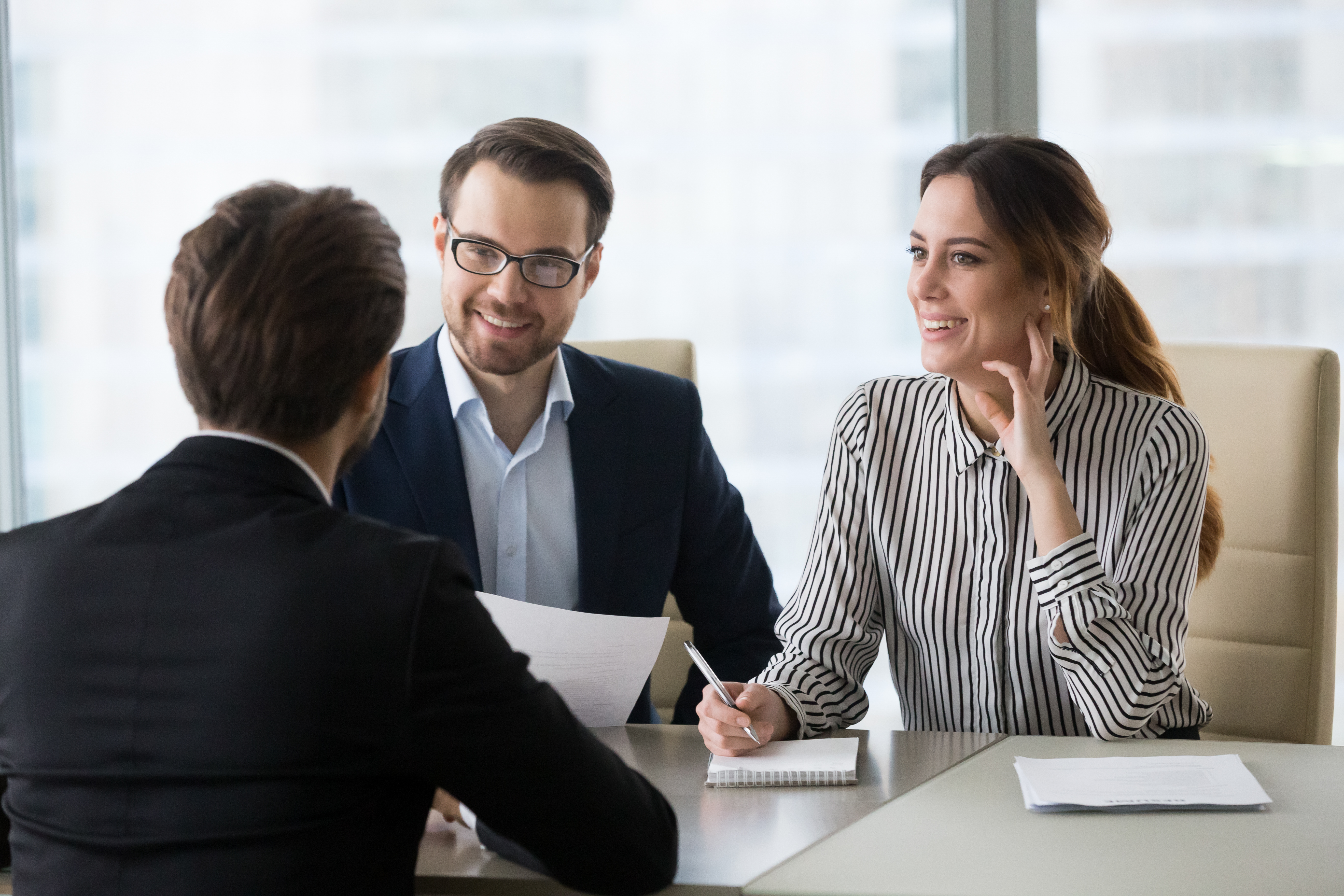 Man and women in corporate attire in a business meeting 