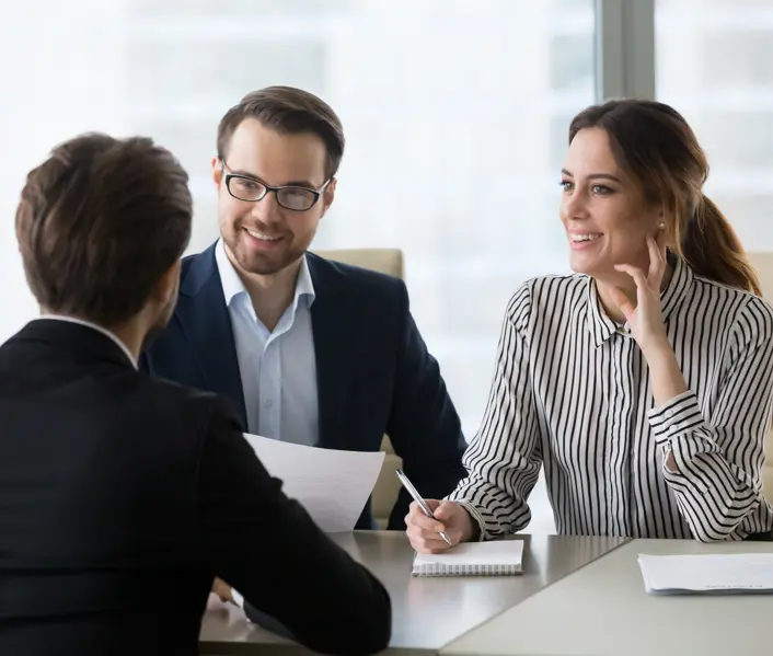 Man and women in corporate attire in a business meeting 