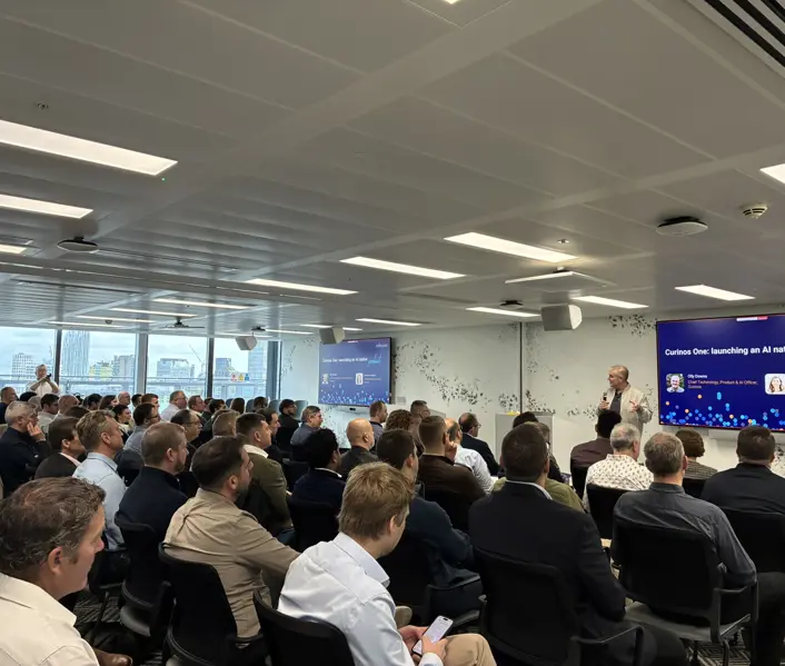 Technology leaders in the audience listening to a presentation