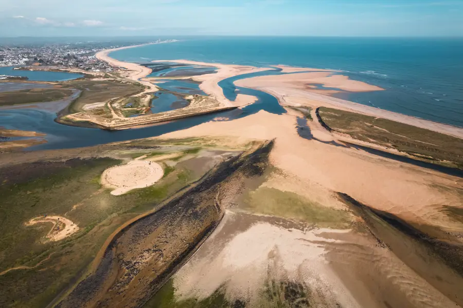 Aerial view of Christchurch Harbour and Mudeford Sandbank, Dorset, with tidal sand flats and the English Channel beyond.