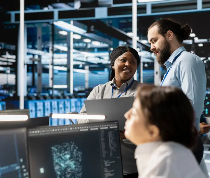 Team of engineers in data center integrating AI driven automation tools