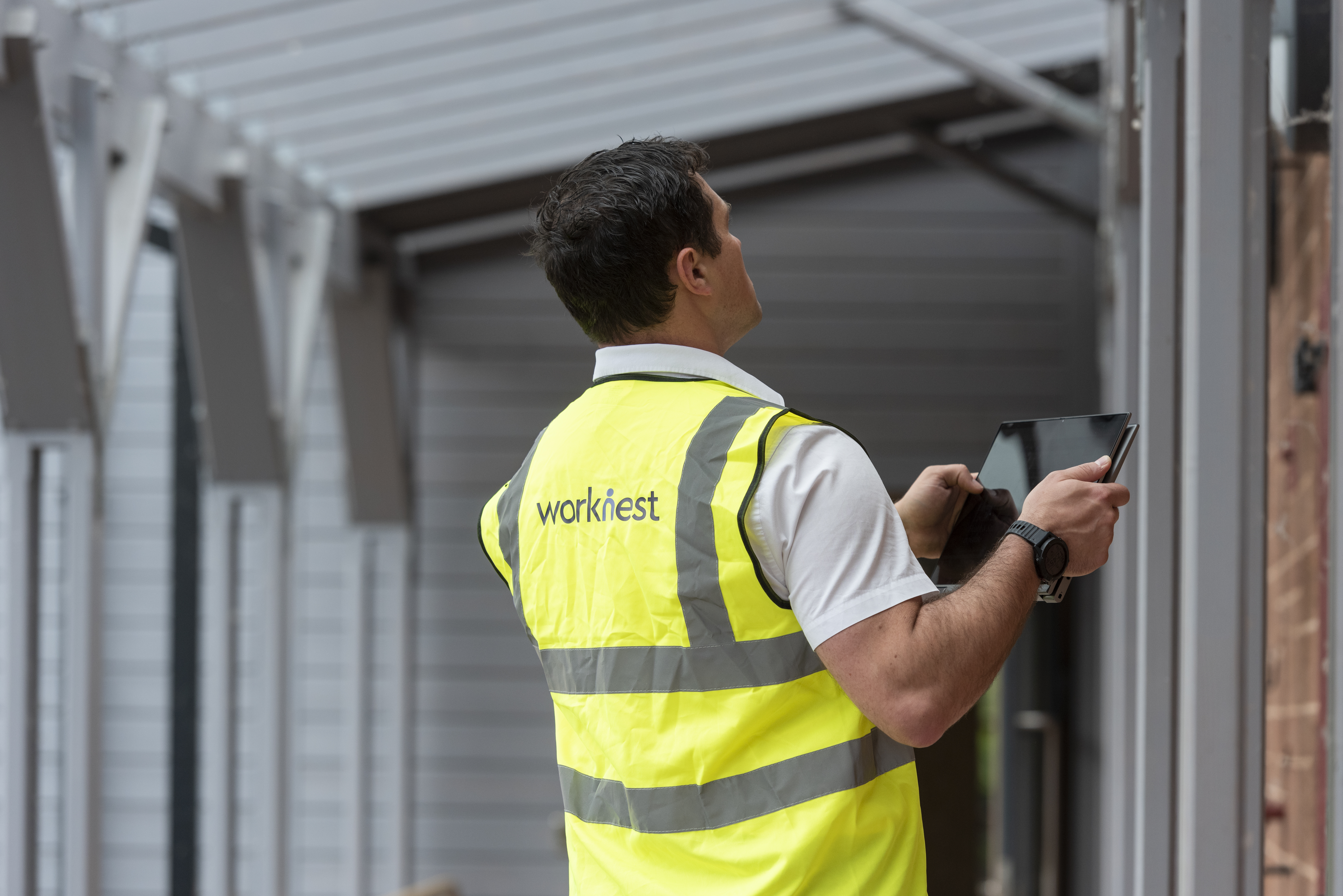 Axiom GRC man using a tablet to carry out a compliance check 